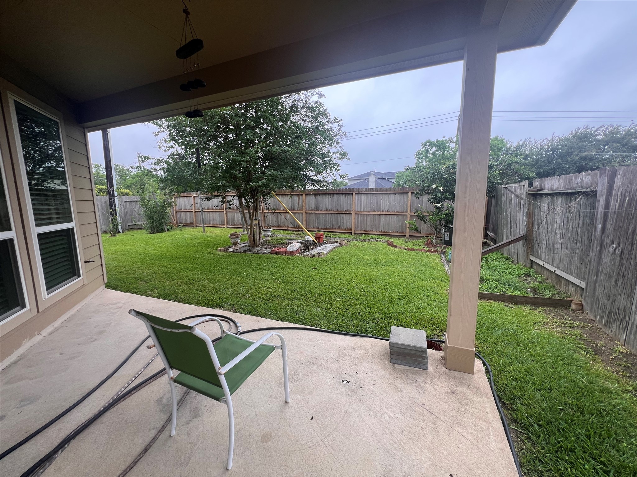 5410 Peppermint Lane Baytown, TX 77521 - Photo 21 of 22 The covered patio extends your living space outdoors, providing a comfortable place to relax while overlooking the private backyard and established landscaping.