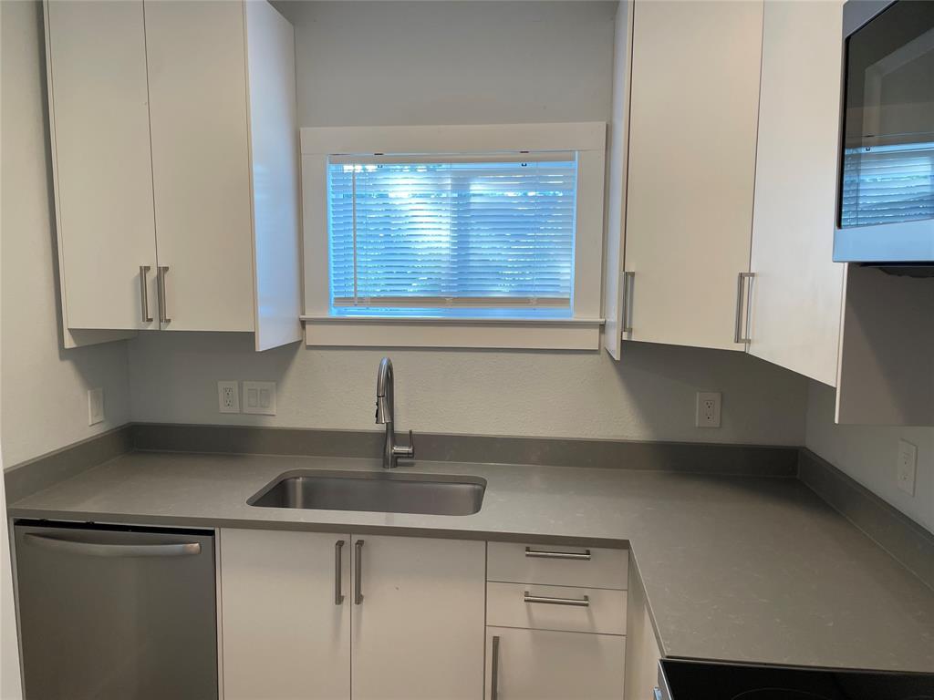 10310 Gail Road, Unit B Austin, TX 78748 - Photo 3 of 12 Modern kitchen with sleek countertops and ample cabinetry provides an ideal culinary space.