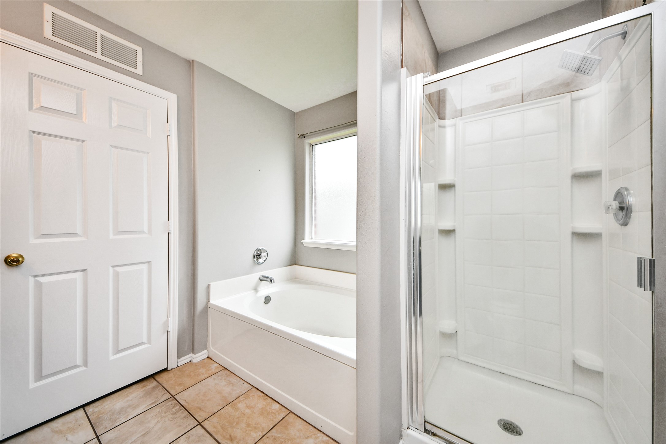 24019 Kingbriar Drive Spring, TX 77373 - Photo 32 of 41 This private bathroom is equipped with both a deep soaking garden tub and a separate glass-enclosed shower, providing a spa-like retreat.
