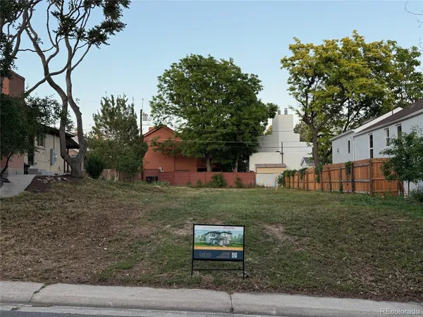 a house with green field in front of it