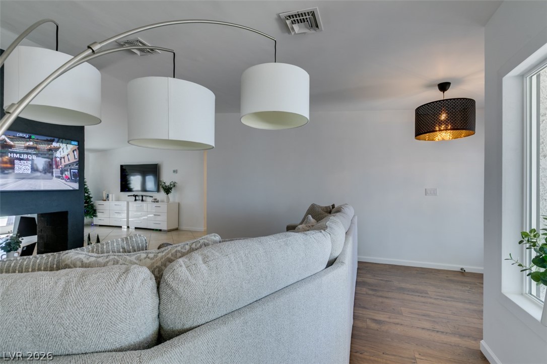 892 North Hollywood Boulevard Las Vegas, NV 89110 - Photo 22 of 81 This bright living space features wood flooring and ample natural light from large windows.