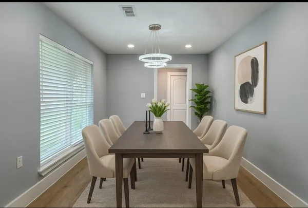 a dining room with furniture and window