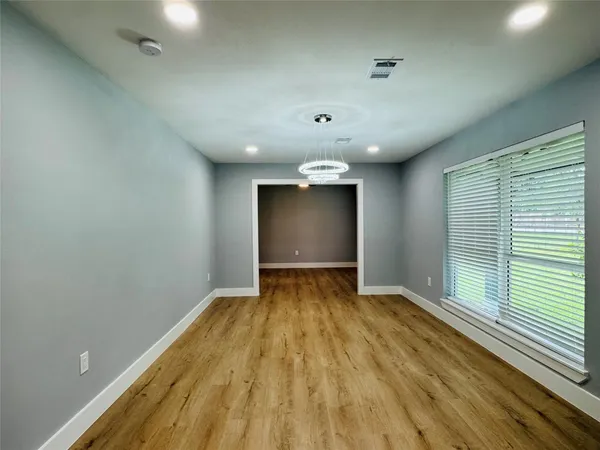 a view of room with window and wooden floor