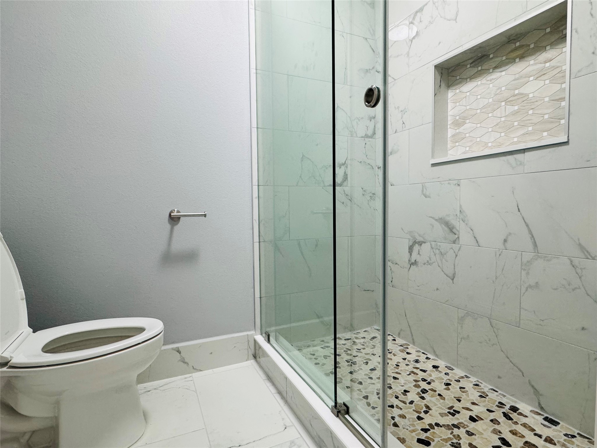 10934 Lilleux Road Houston, TX 77067 - Photo 16 of 27 a bathroom with a toilet and shower