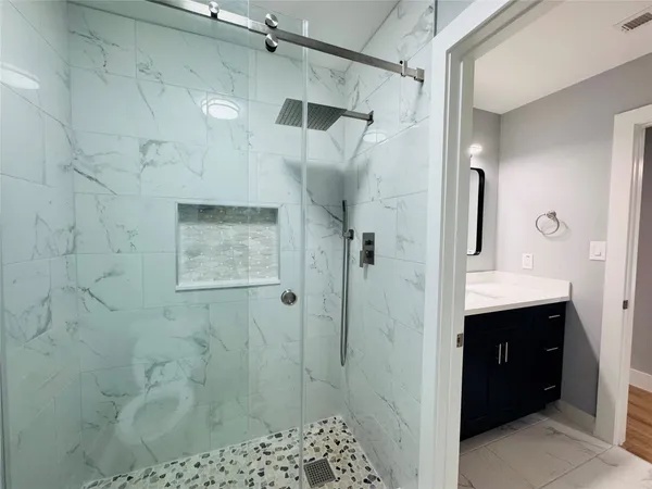 a bathroom with a shower and a sink