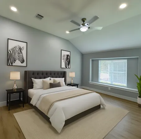 a bedroom with a large bed and a chandelier