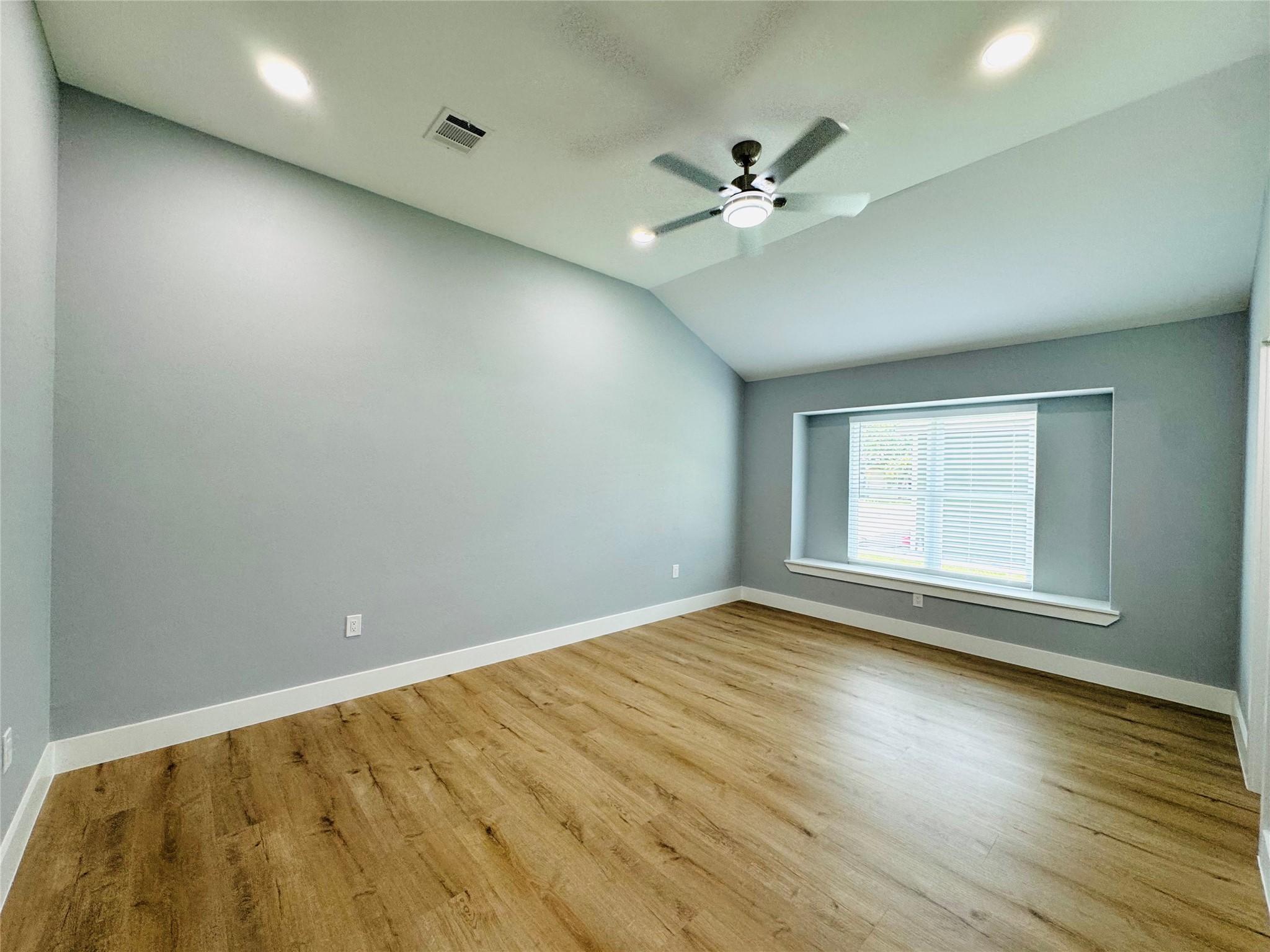 10934 Lilleux Road Houston, TX 77067 - Photo 19 of 27 a view of an empty room with wooden floor and a window