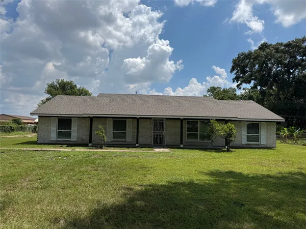 a front view of a house with yard and green space