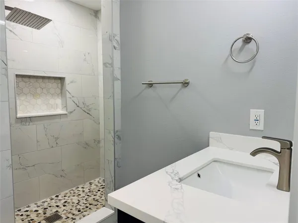 a bathroom with a sink and a shower