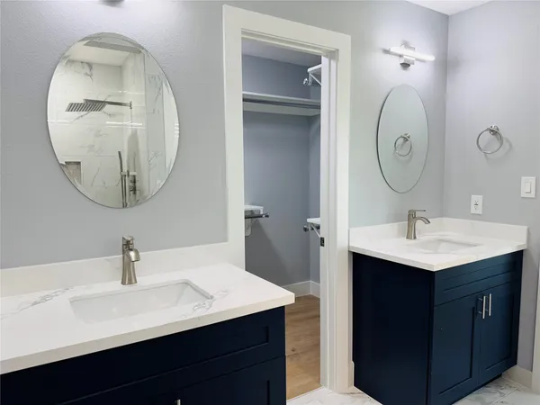 a bathroom with a sink vanity and a mirror