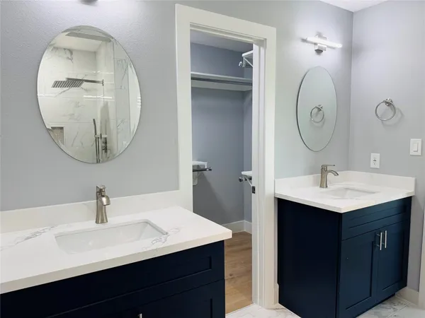 a bathroom with a sink vanity and a mirror
