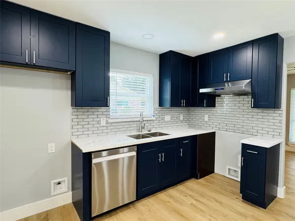 a kitchen with a sink and wooden cabinets