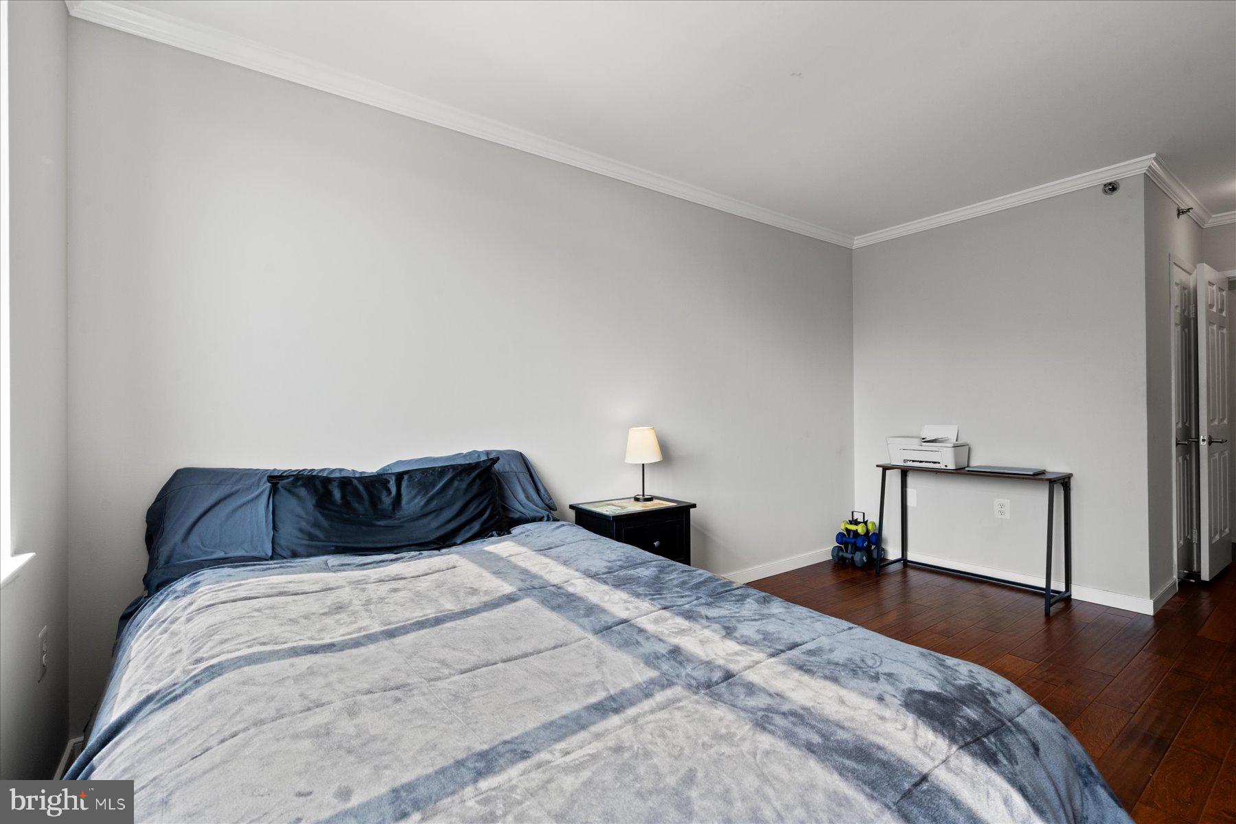 4801 Fairmont Avenue, Unit 705 Bethesda, MD 20814 - Photo 11 of 19 a bedroom with a bed and wooden floor