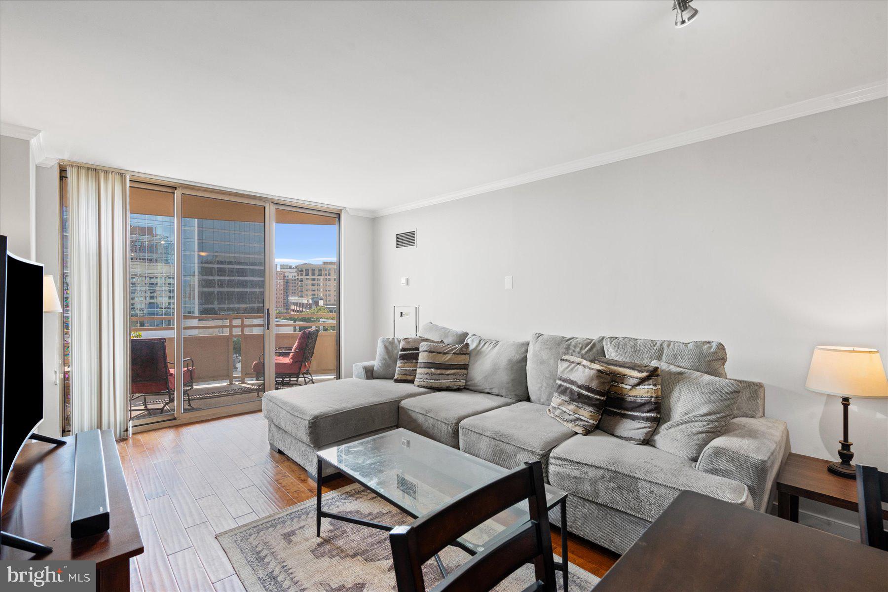 4801 Fairmont Avenue, Unit 705 Bethesda, MD 20814 - Photo 2 of 19 a living room with furniture and a flat screen tv