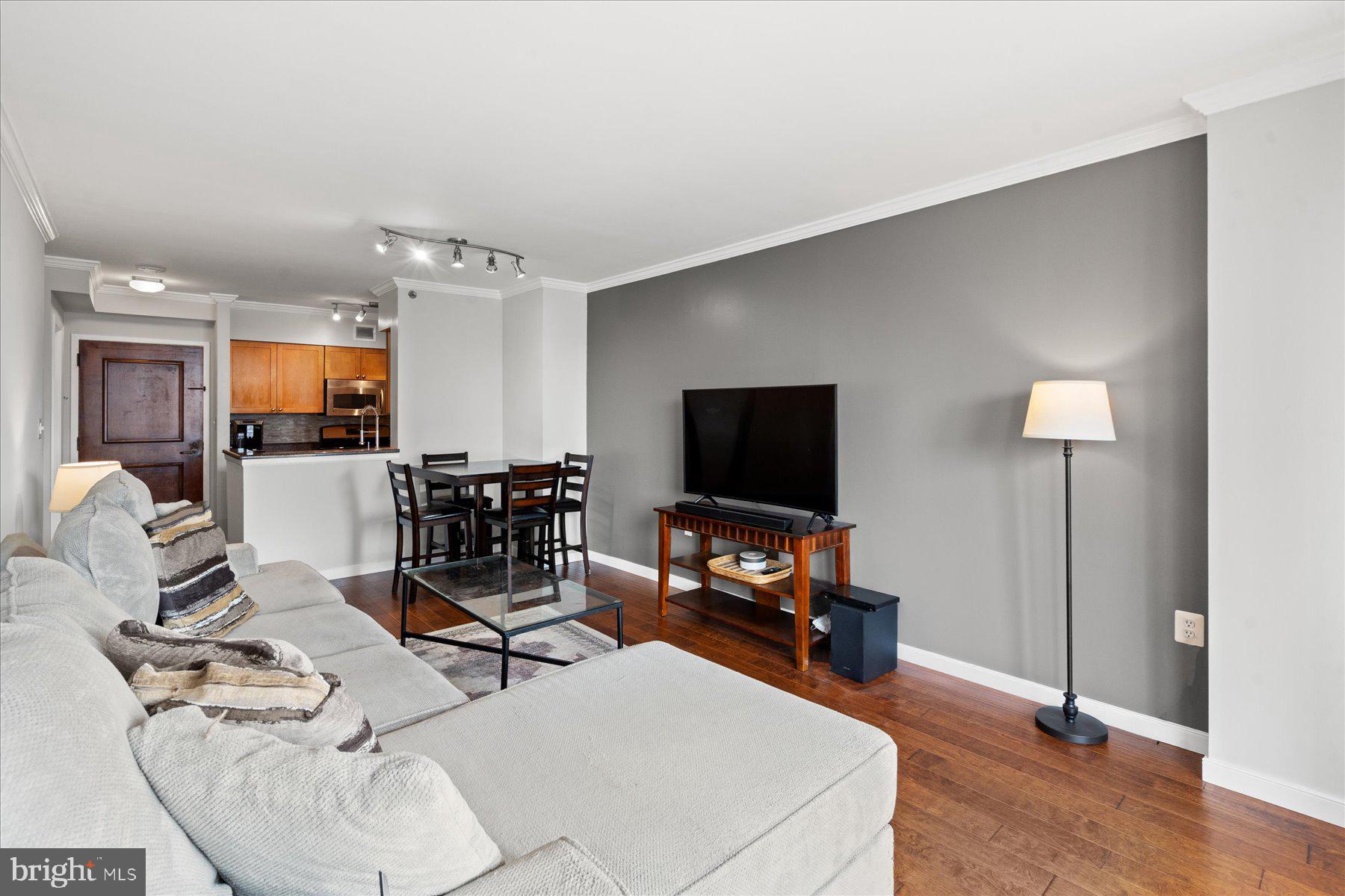 4801 Fairmont Avenue, Unit 705 Bethesda, MD 20814 - Photo 3 of 19 a living room with furniture and a flat screen tv