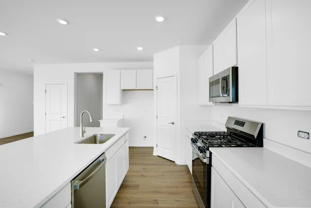 a kitchen with a sink stove and refrigerator