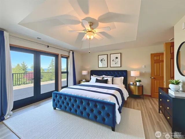 a bedroom with a large bed and a chandelier fan