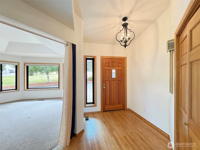 a view of a room with wooden floor and windows