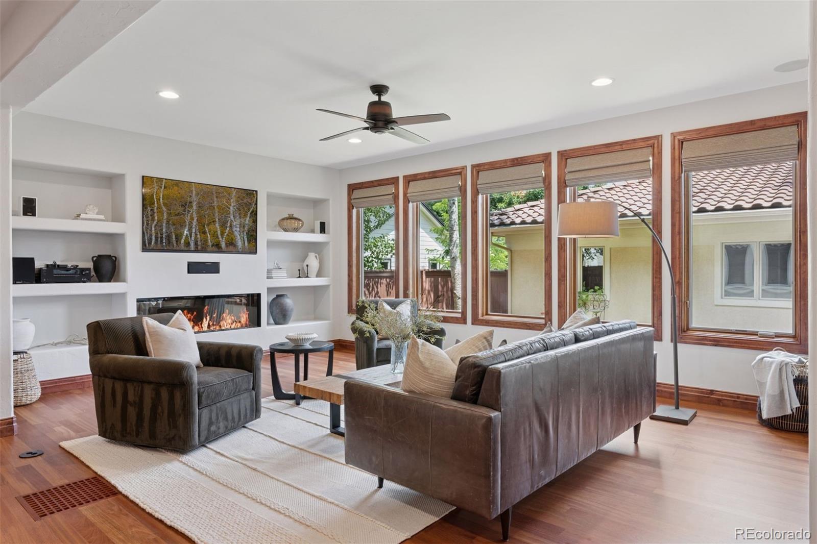 1026 South Cook Street Denver, CO 80209 - Photo 16 of 44 a living room with furniture flat screen tv and large windows