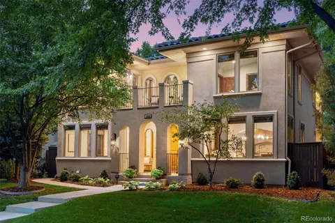 a front view of a house with a yard and outdoor seating