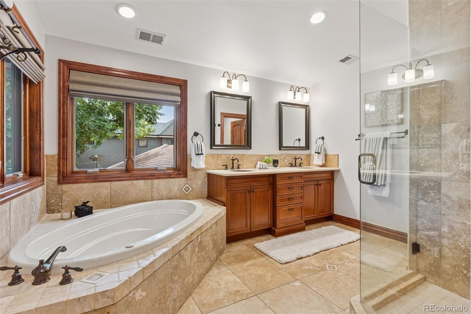1026 South Cook Street Denver, CO 80209 - Photo 22 of 41 a bathroom with a tub sink and mirror
