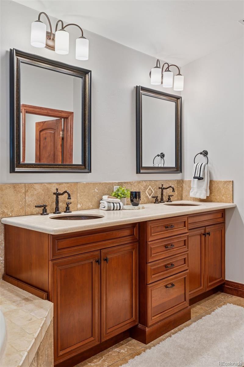1026 South Cook Street Denver, CO 80209 - Photo 26 of 44 a bathroom with a granite countertop sink vanity and mirror