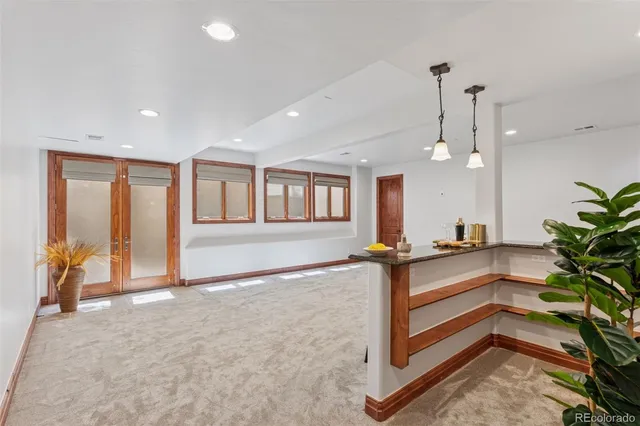 a view of hall way with furniture and wooden floor