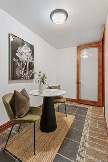 a view of a dinning table and chairs in patio