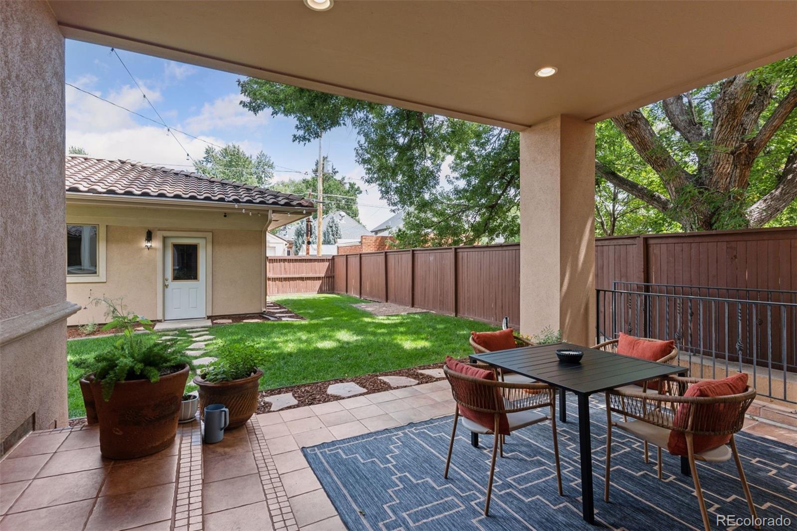 1026 South Cook Street Denver, CO 80209 - Photo 37 of 39 a view of a table and chairs in back yard of a house