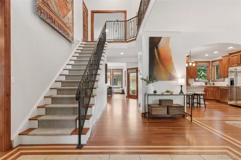 a view of entryway and hall with wooden floor