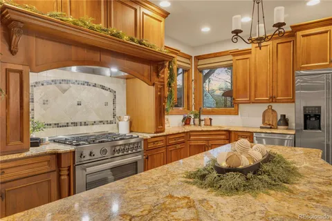 a kitchen with stainless steel appliances granite countertop a stove and a sink
