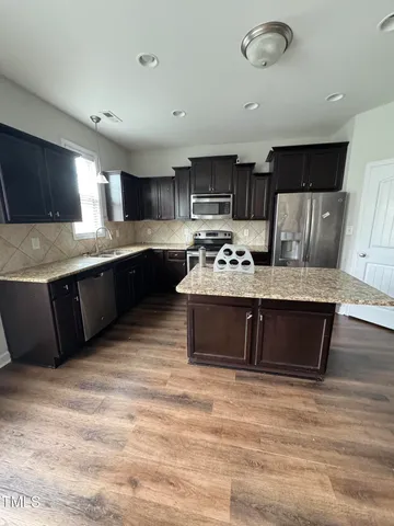 a kitchen with stainless steel appliances granite countertop a stove sink and cabinets