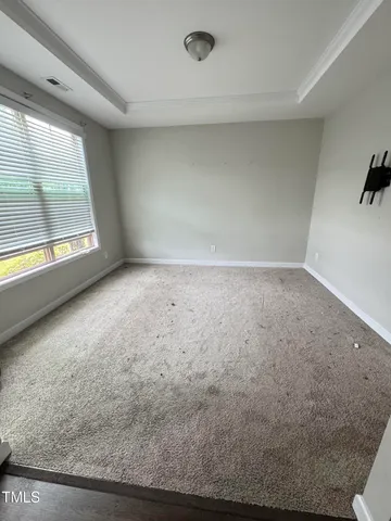 an empty room with a empty space and windows