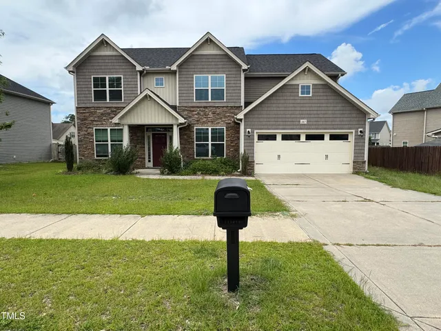 a front view of a house with a yard