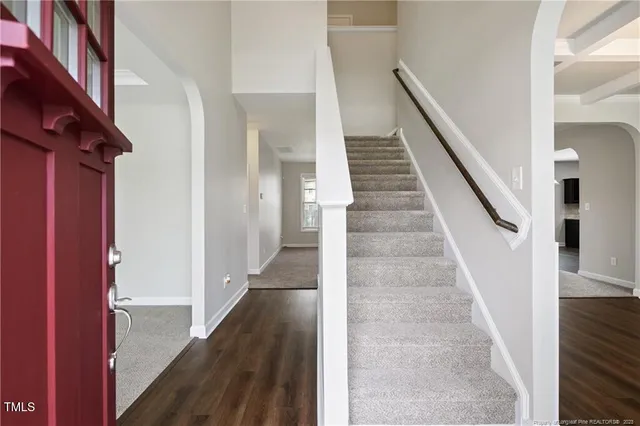 a view of entryway with wooden floor and stairs