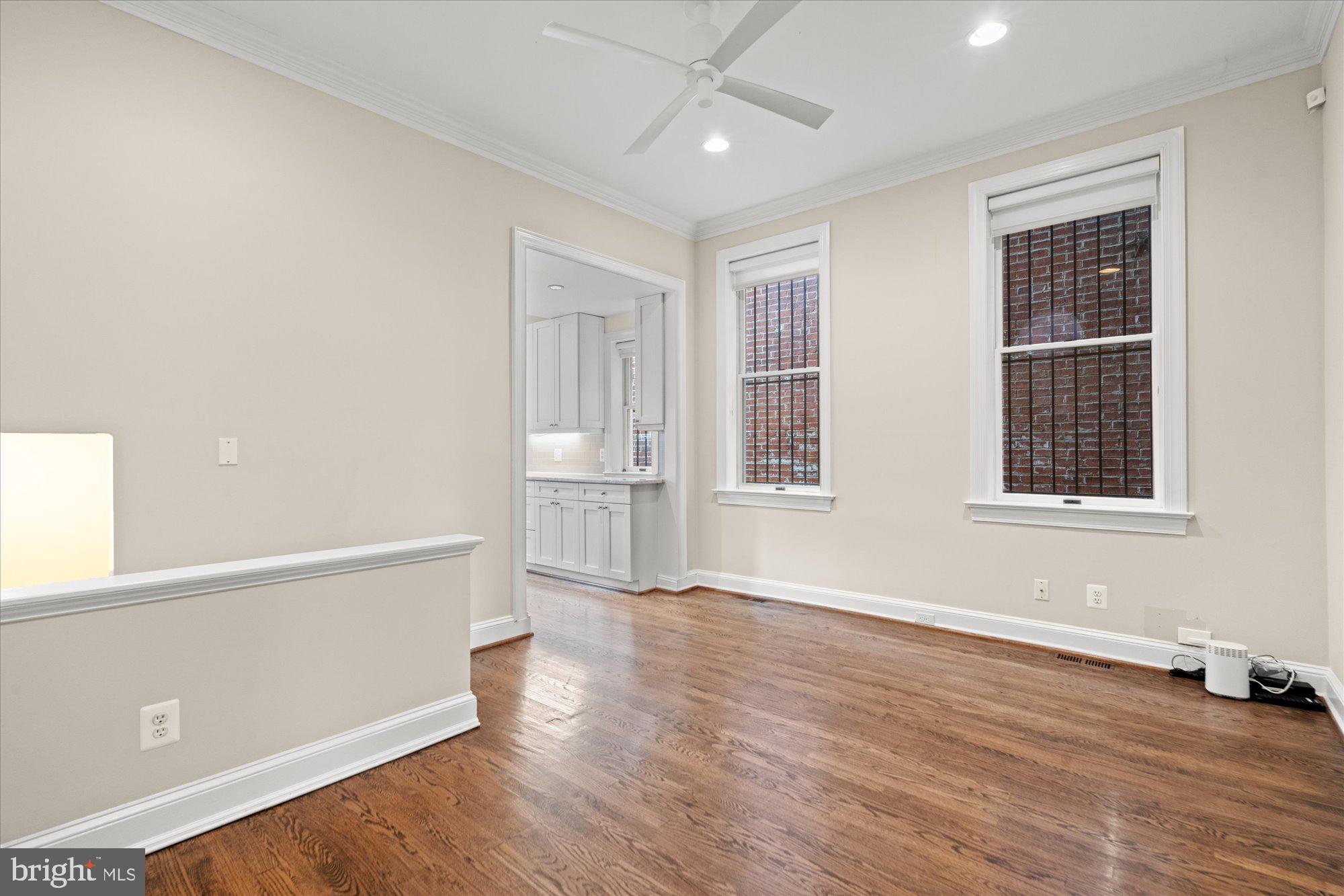 1209 S Street Northwest Washington, DC 20009 - Photo 11 of 64 an empty room with wooden floor and windows