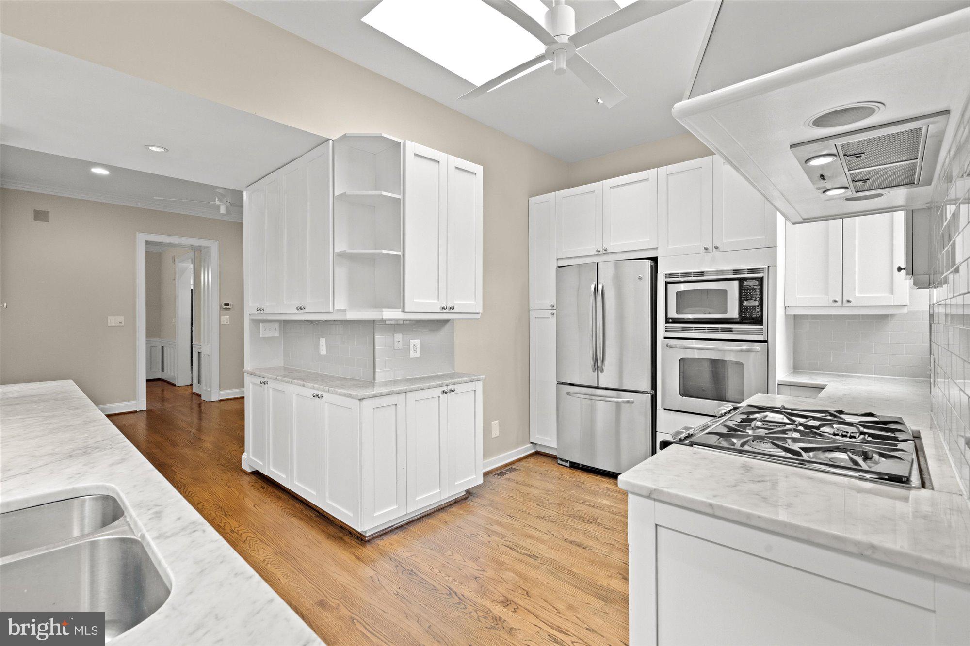 1209 S Street Northwest Washington, DC 20009 - Photo 12 of 64 a kitchen with cabinets and stainless steel appliances