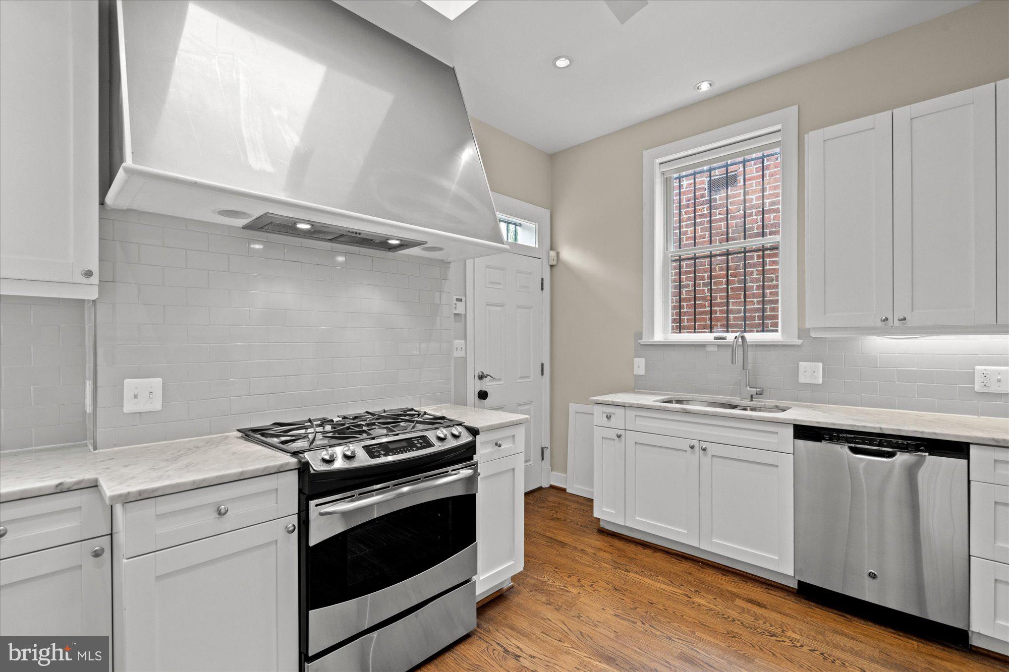 1209 S Street Northwest Washington, DC 20009 - Photo 16 of 64 a kitchen with stainless steel appliances white cabinets and a sink