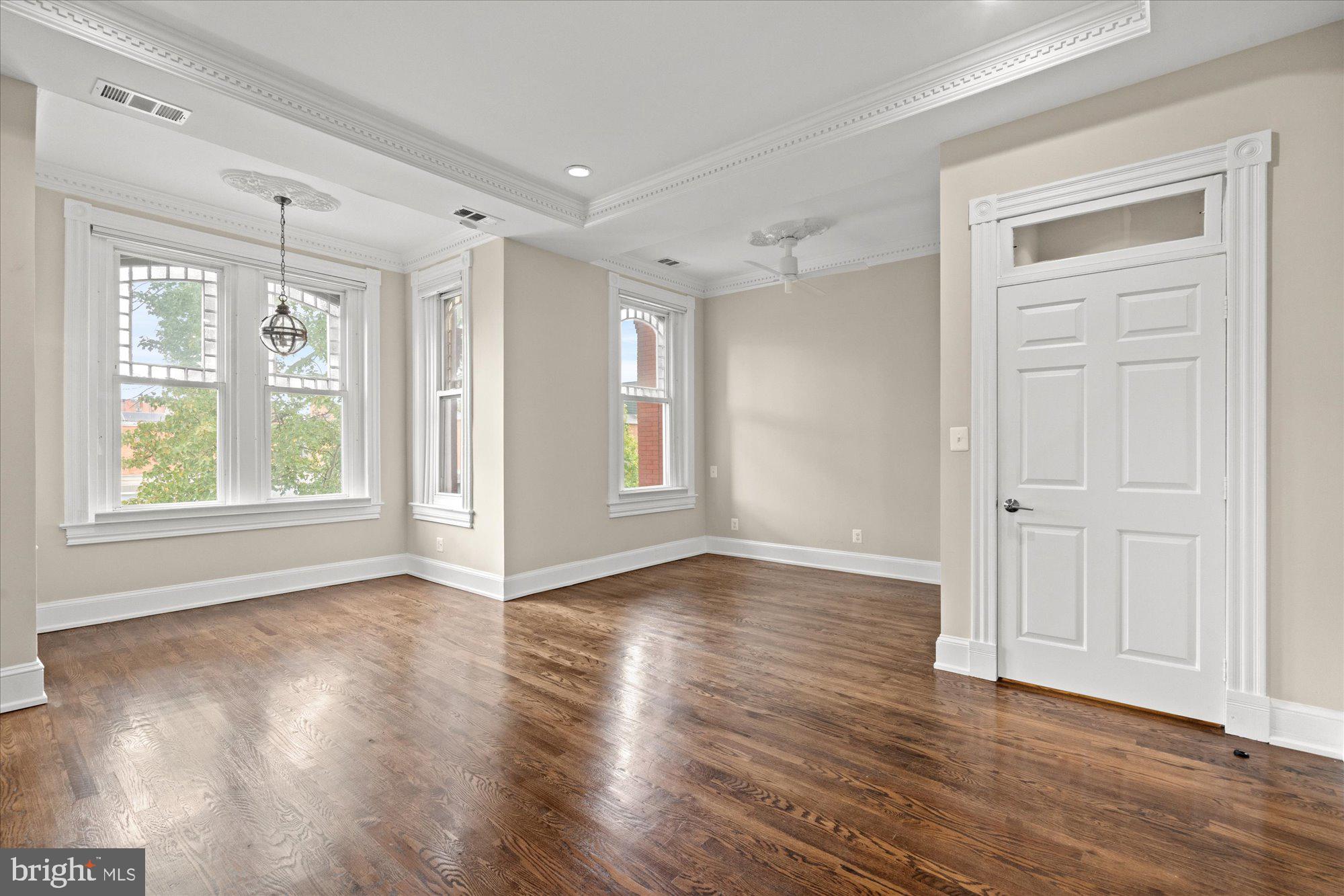 1209 S Street Northwest Washington, DC 20009 - Photo 20 of 64 a view of an empty room with wooden floor and a window