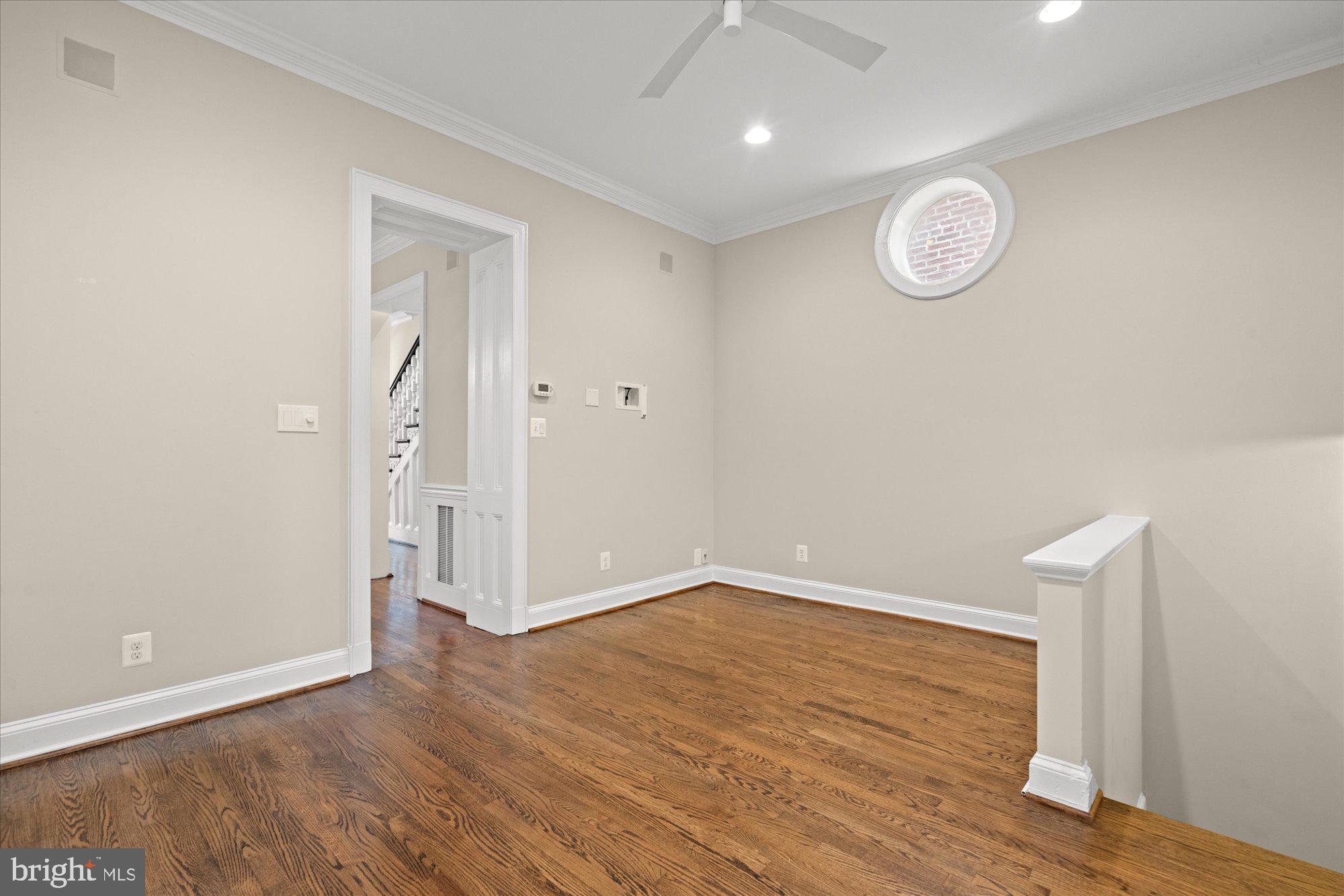 1209 S Street Northwest Washington, DC 20009 - Photo 32 of 64 a view of an empty room with wooden floor