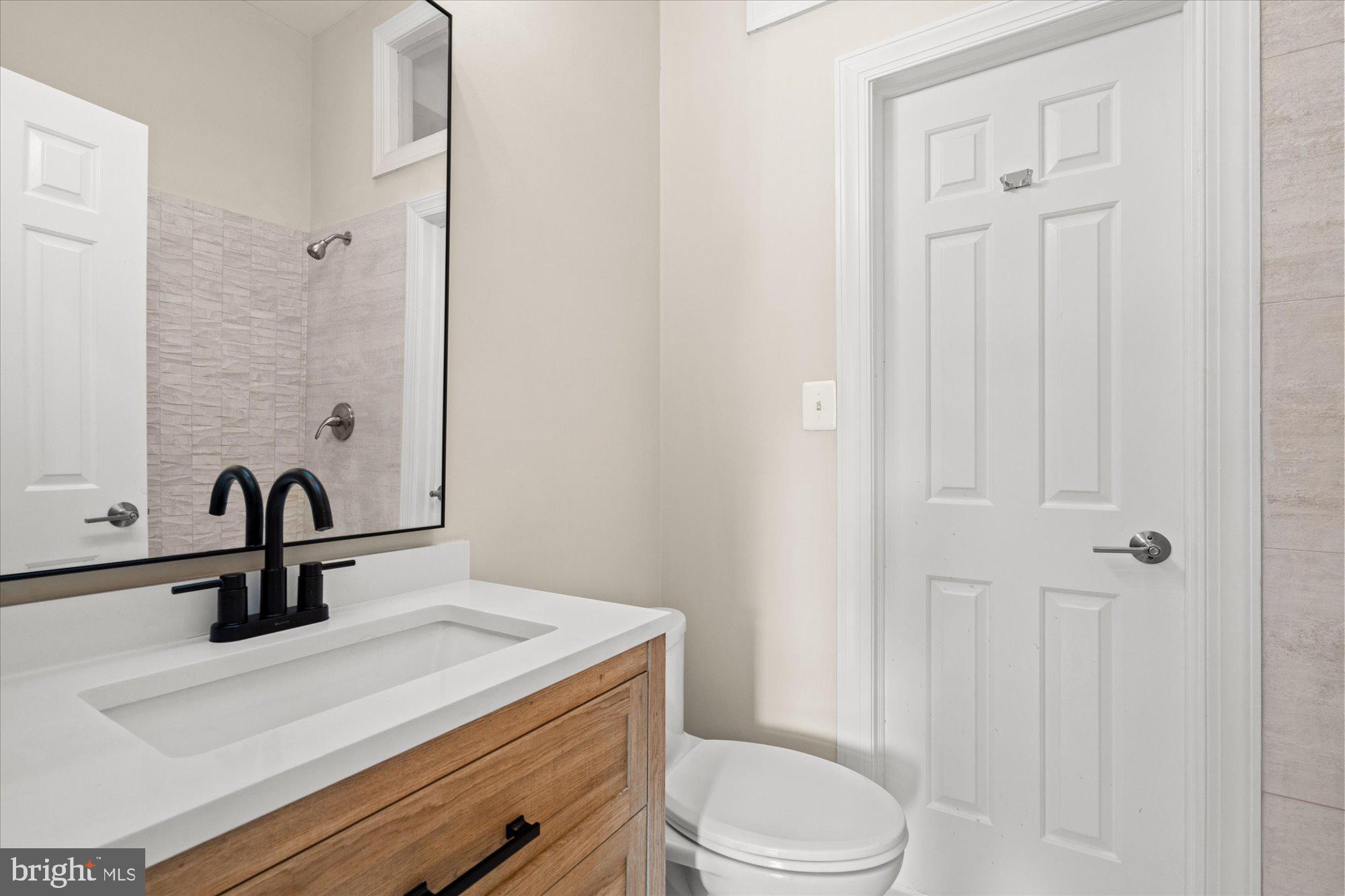 1209 S Street Northwest Washington, DC 20009 - Photo 35 of 64 a bathroom with a sink a toilet and shower