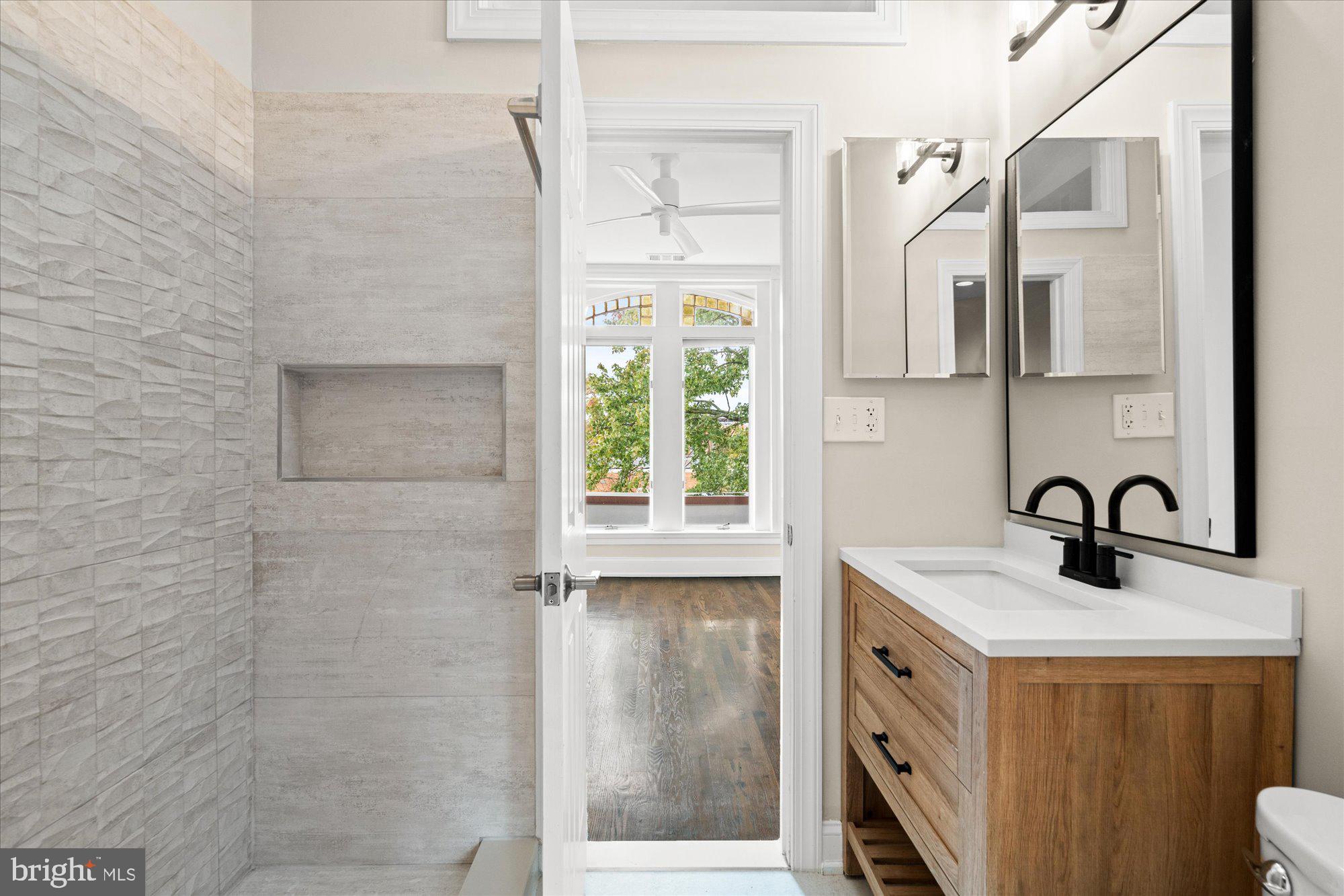 1209 S Street Northwest Washington, DC 20009 - Photo 36 of 64 a bathroom with a sink and a mirror