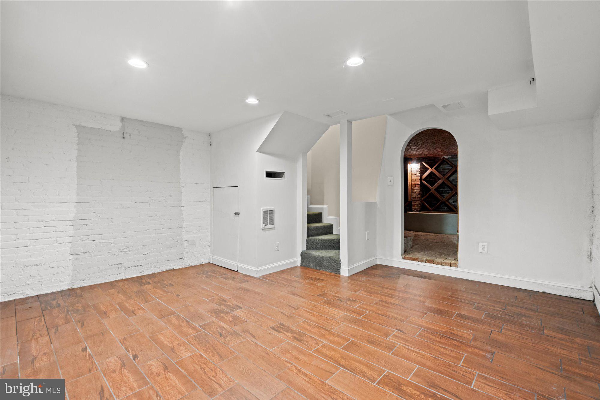 1209 S Street Northwest Washington, DC 20009 - Photo 38 of 64 wooden floor in an empty room with a window