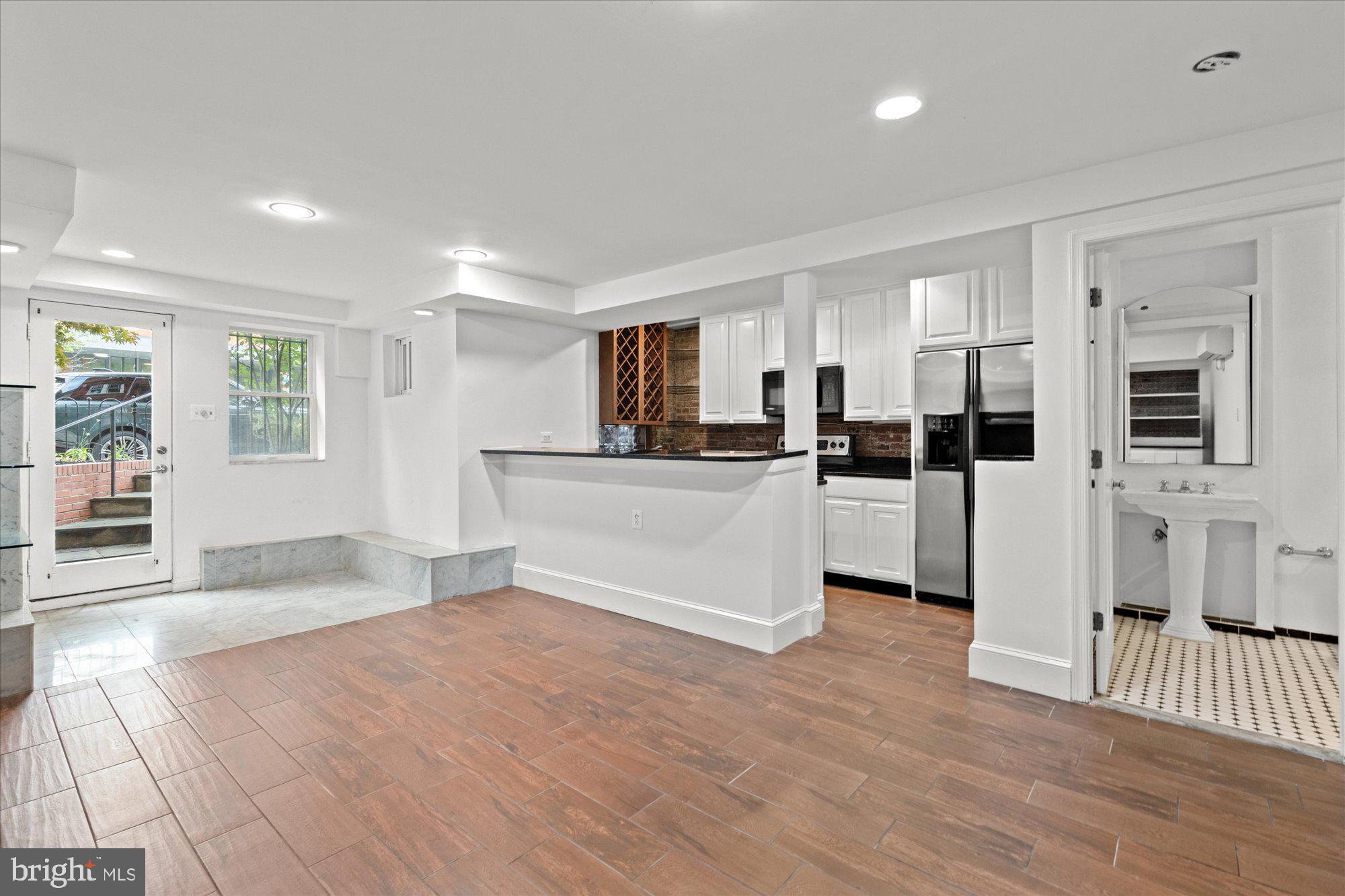 1209 S Street Northwest Washington, DC 20009 - Photo 45 of 64 a view of a kitchen with furniture and wooden floor
