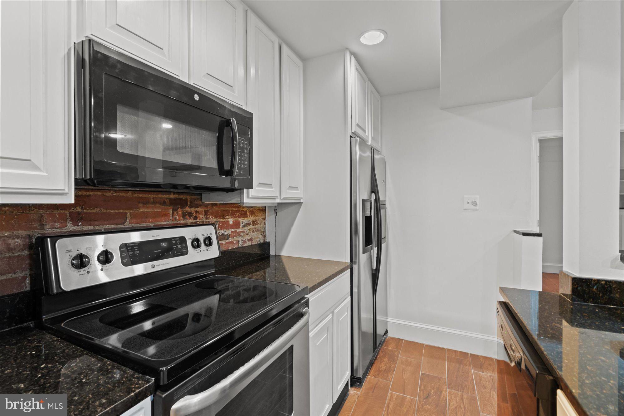 1209 S Street Northwest Washington, DC 20009 - Photo 49 of 64 a kitchen with a stove and a microwave