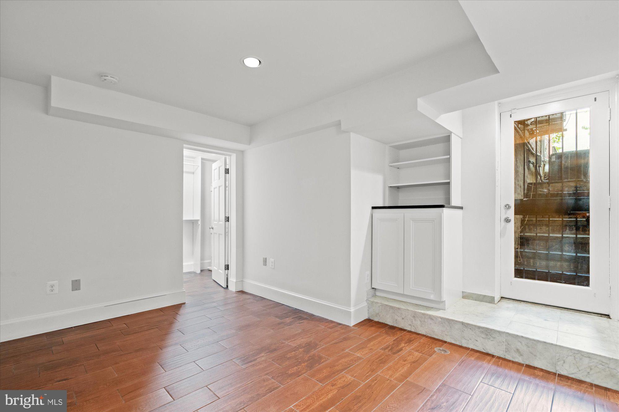 1209 S Street Northwest Washington, DC 20009 - Photo 50 of 64 wooden floor in an empty room with a window
