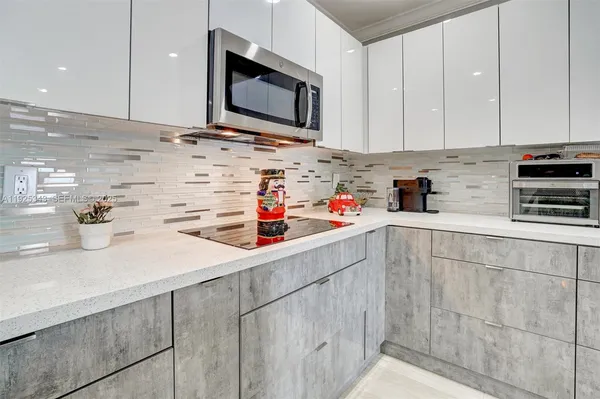 a kitchen with stainless steel appliances a sink dishwasher a microwave and cabinets