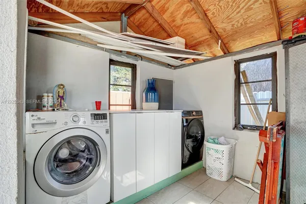 a view of a storage & utility room with dryer and washer