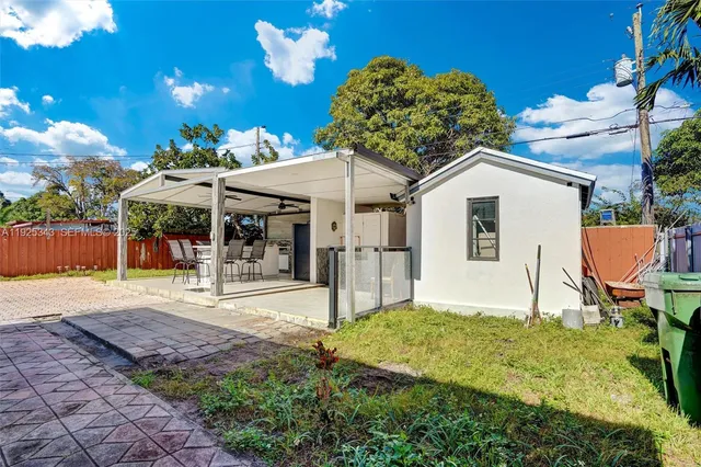 a front view of a house with a yard and a garden