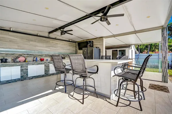 a view of a chairs and table in the balcony
